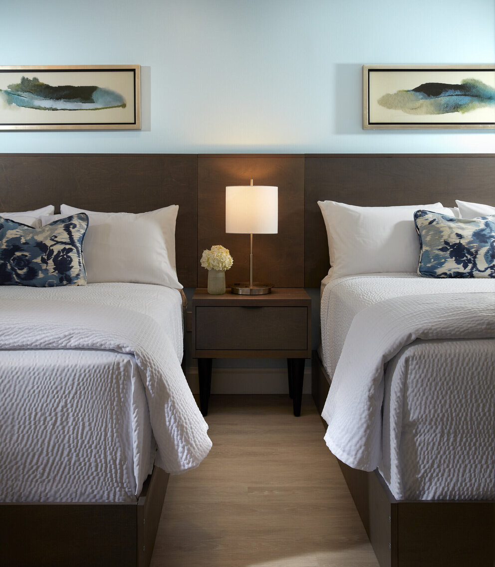 two beds and nightstand at our jupiter beach hotel