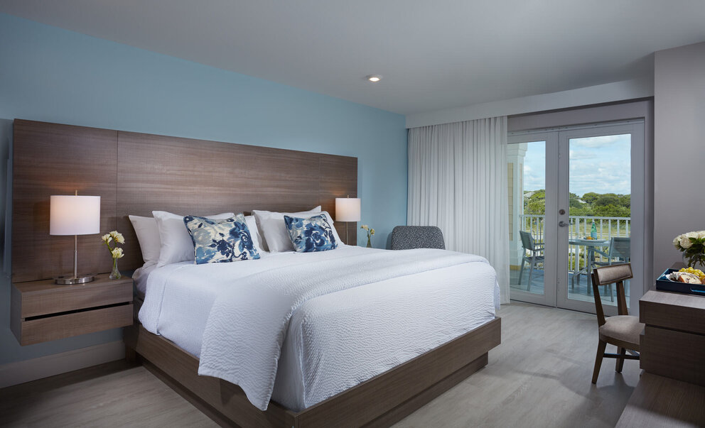 bed with bedside tables at our jupiter beach hotel