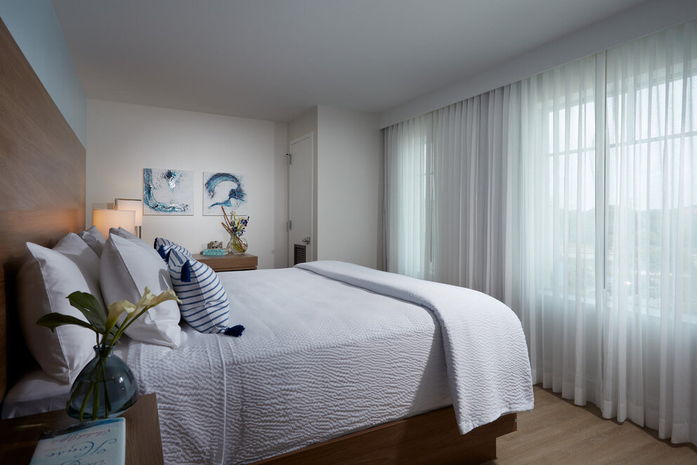 bed facing window at our jupiter beach hotel